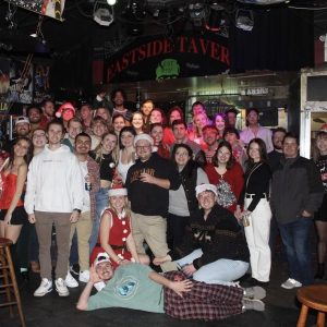 a big group photo of students at a bar